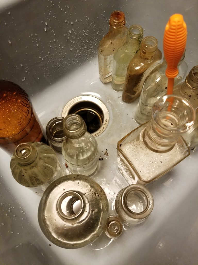 Washing vintage bottles found in the woods